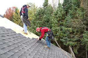 Two Roofers Installing Shingles