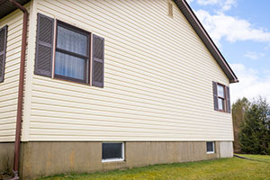 Side of house with repaired vinyl siding.